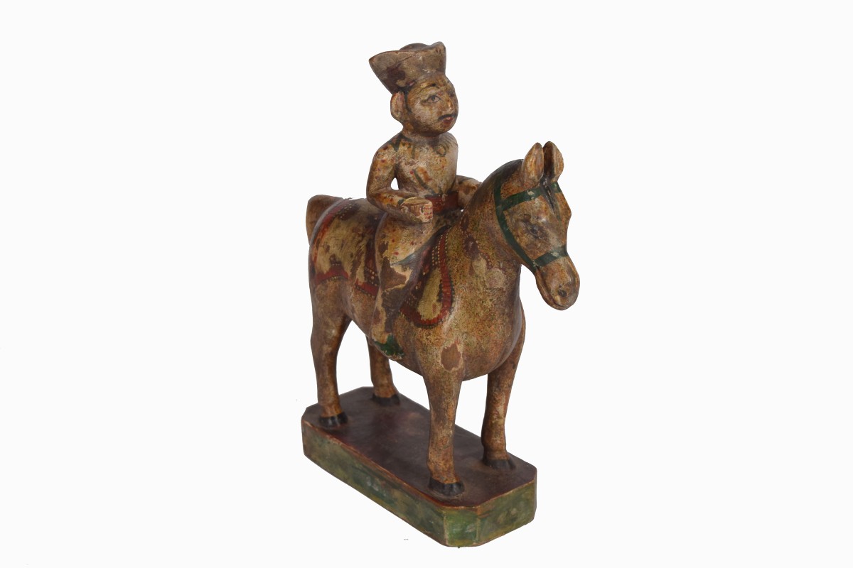 Hand carved wooden man on horse