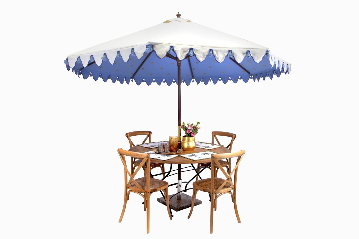 Celeste blue sunshade with round bistro table and cross back chairs