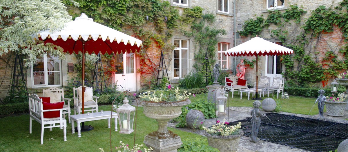 indian white & pink sunshades in garden & garden set besides house