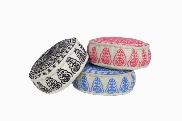 Round embroidered linen pouffes