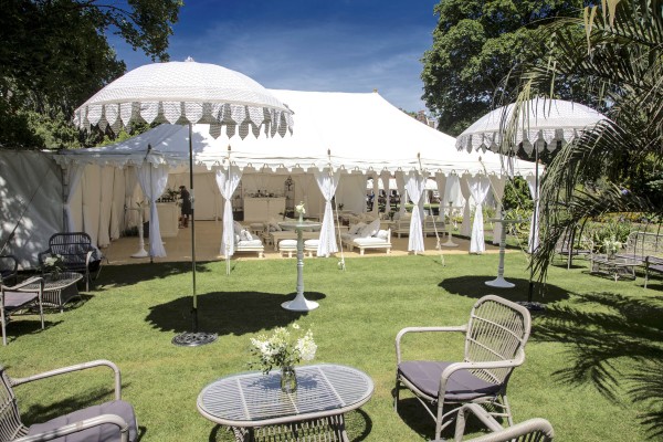 A Double Maharaja with furniture and parasols on the lower lawn at Chelsea Physic Garden