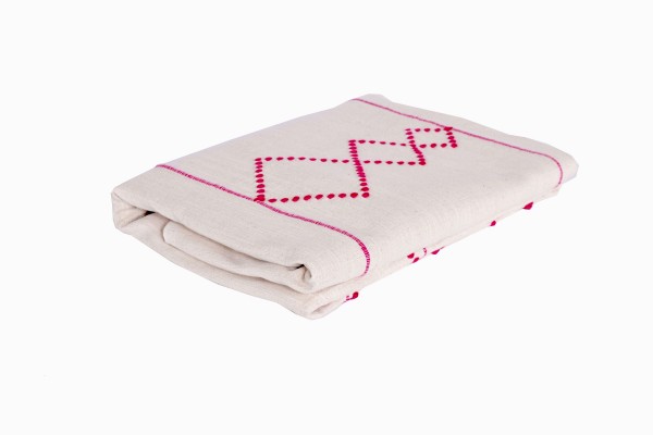 Moroccan pink and cream diamond bedspread folded