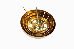 Beaten brass bowls with spoons