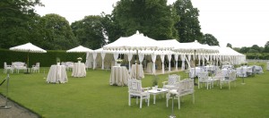 indian white sunshades in a row in garden with garden set