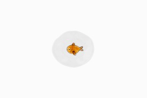 Tiny porcelain dish with a fat brown fish