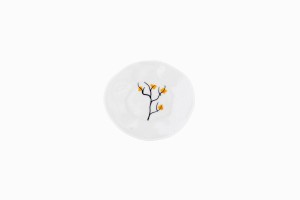 Tiny porcelain dish with yellow blossom