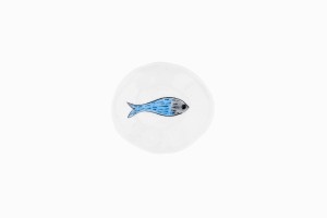 Tiny porcelain dish with blue fish swimming to the right