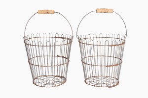 A pair of vintage wire baskets with wood handles